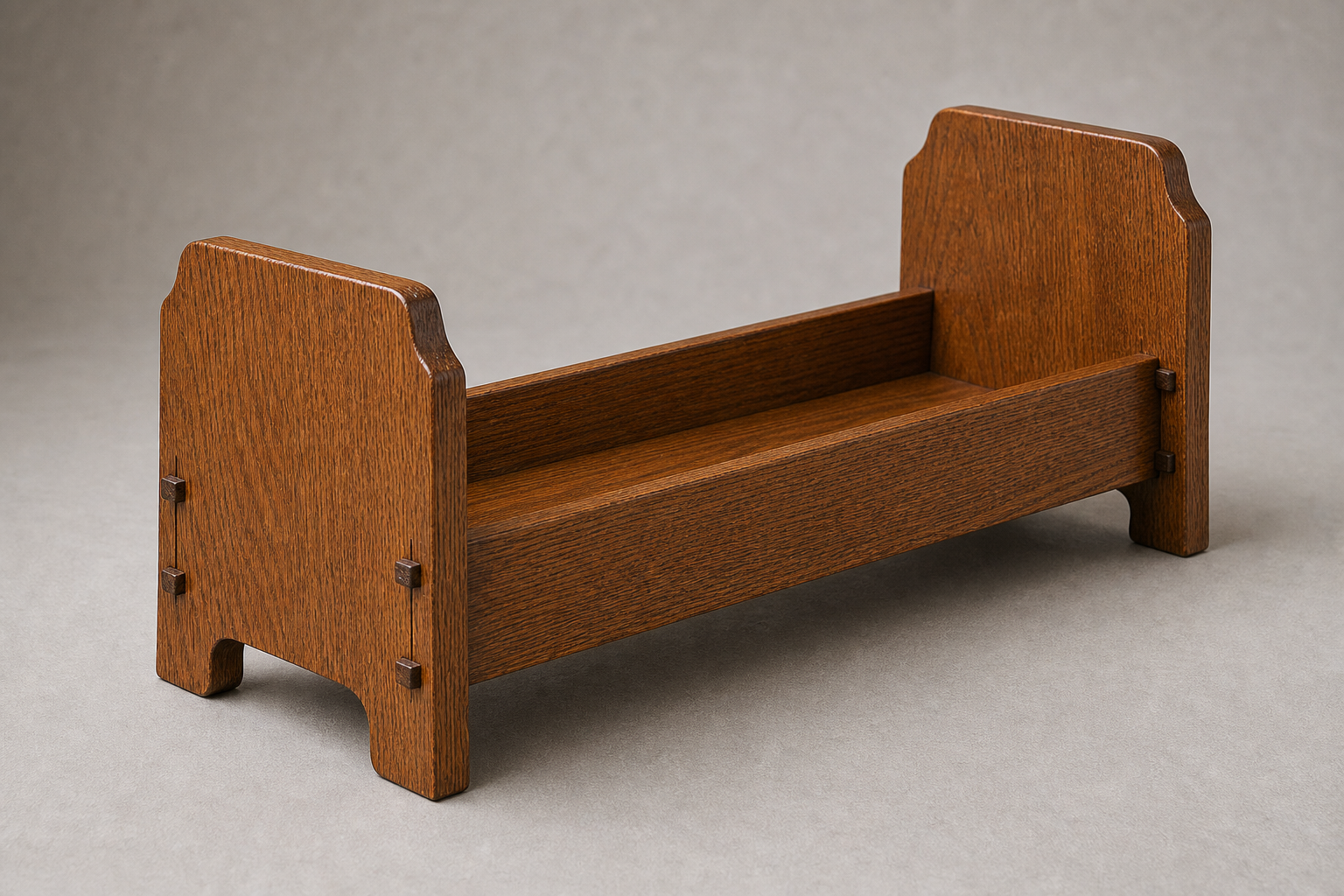 Mission-style oak book trough with wedge joints and a curved base cutout holding books
